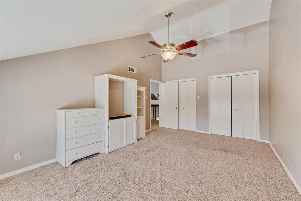 1242 Signal Ridge Place Rockwall, TX 75032 - Photo 16 of 27 a view of a livingroom with furniture cabinet and a ceiling fan