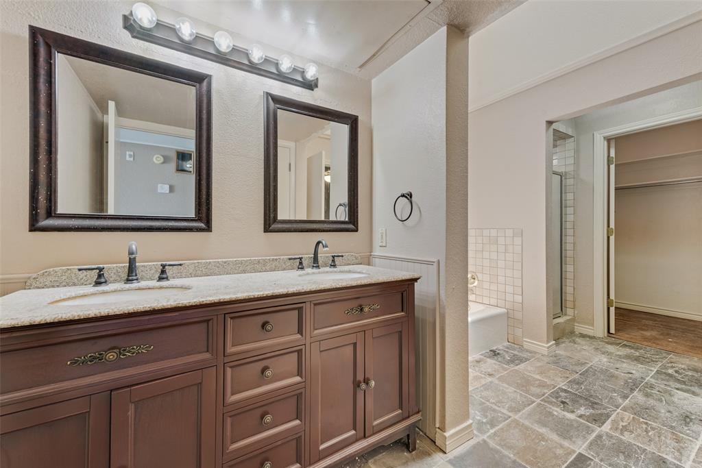 1242 Signal Ridge Place Rockwall, TX 75032 - Photo 20 of 27 a bathroom with a double vanity sink and a mirror