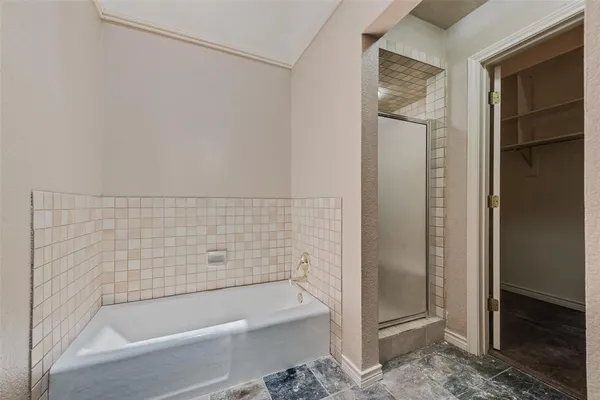 a bathroom with bathtub and shower