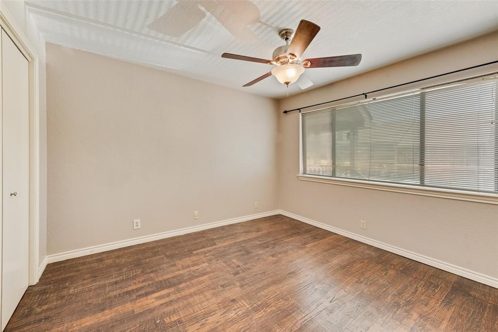 1242 Signal Ridge Place Rockwall, TX 75032 - Photo 25 of 27 an empty room with wooden floor fan and windows