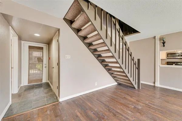 wooden floor with an entryway and hallway with wooden floor