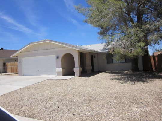 330 East Wilson Avenue Ridgecrest, CA 93555 - Photo 1 of 29 a front view of a house with a yard