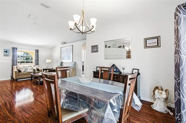 a view of a dining room with furniture wooden floor and chandelier