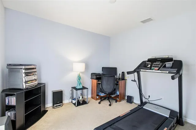 a bedroom with a bed chair and a window