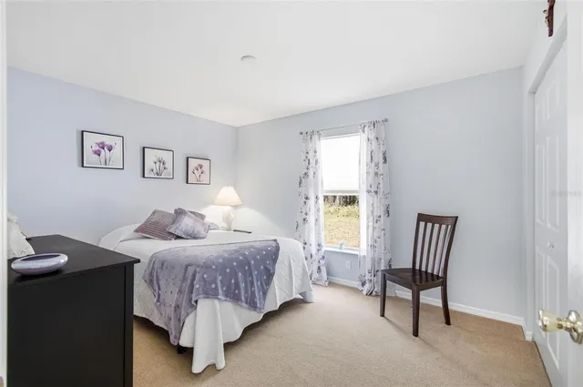 a bedroom with a bed and a lamp