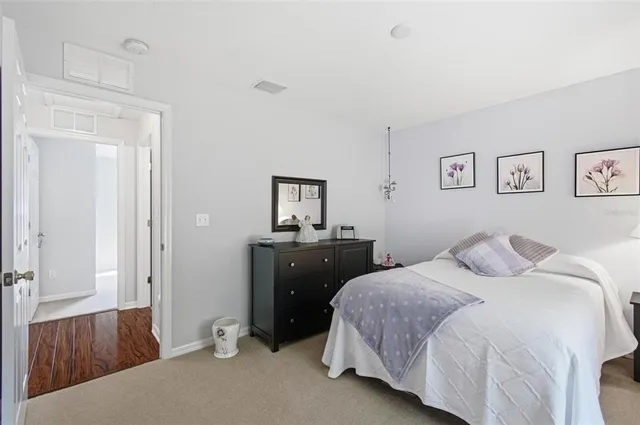 a bedroom with a bed and a lamp