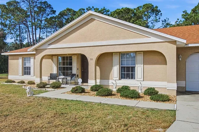 a front view of a house with garden