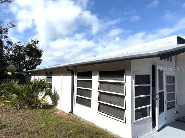 a view of a car in front view of a house