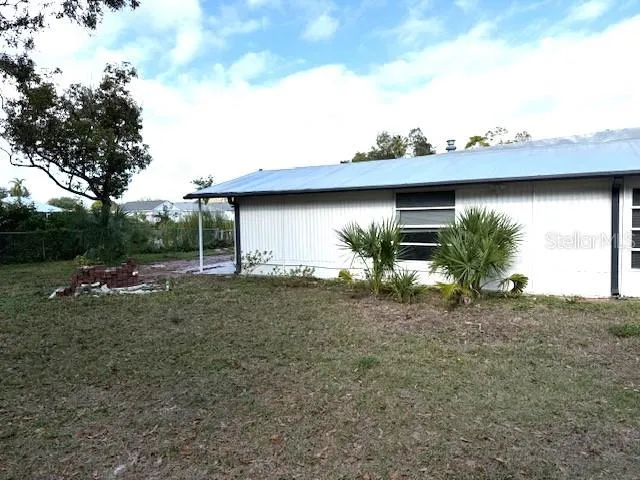 a backyard of a house with table and chairs