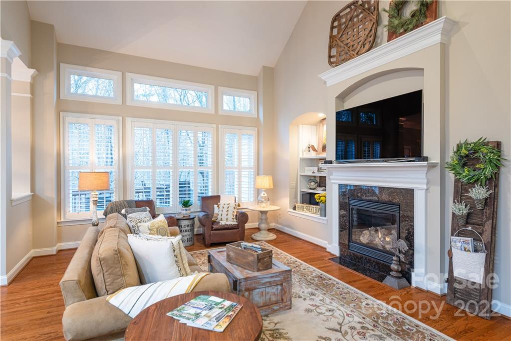 930 Stratford Run Drive Fort Mill, SC 29708 - Photo 12 of 28 a living room with furniture a flat screen tv and a fireplace