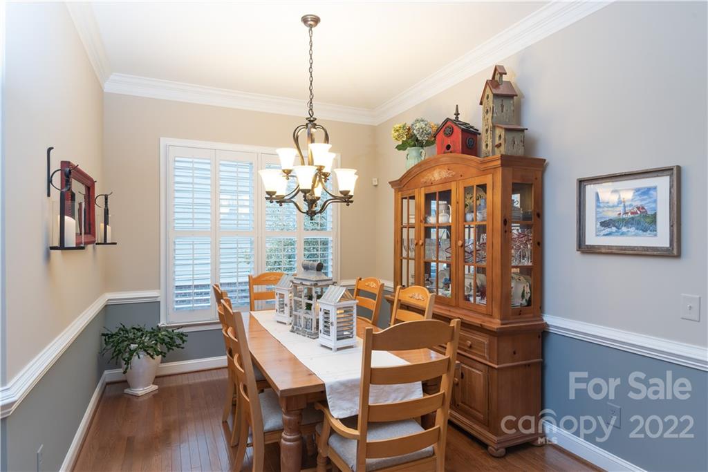 930 Stratford Run Drive Fort Mill, SC 29708 - Photo 5 of 28 a view of a dining room with furniture wooden floor and a chandelier