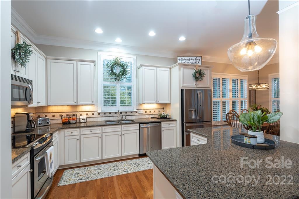 930 Stratford Run Drive Fort Mill, SC 29708 - Photo 6 of 28 a kitchen with stainless steel appliances granite countertop sink stove refrigerator and cabinets
