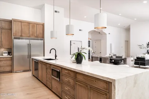 a living room with fireplace furniture and a large window