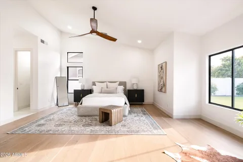 a bedroom with a bed and a painting on the wall