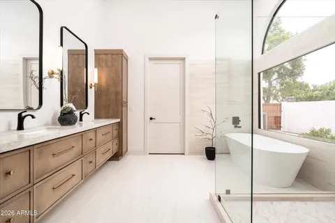 a bathroom with a double vanity sink and mirror