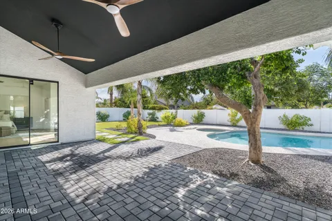 a view of a house with swimming pool and next to a yard