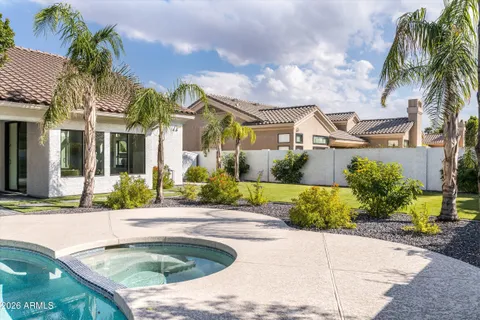 a view of a house with a yard and swimming pool