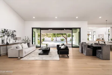 a living room with fireplace furniture and a large window