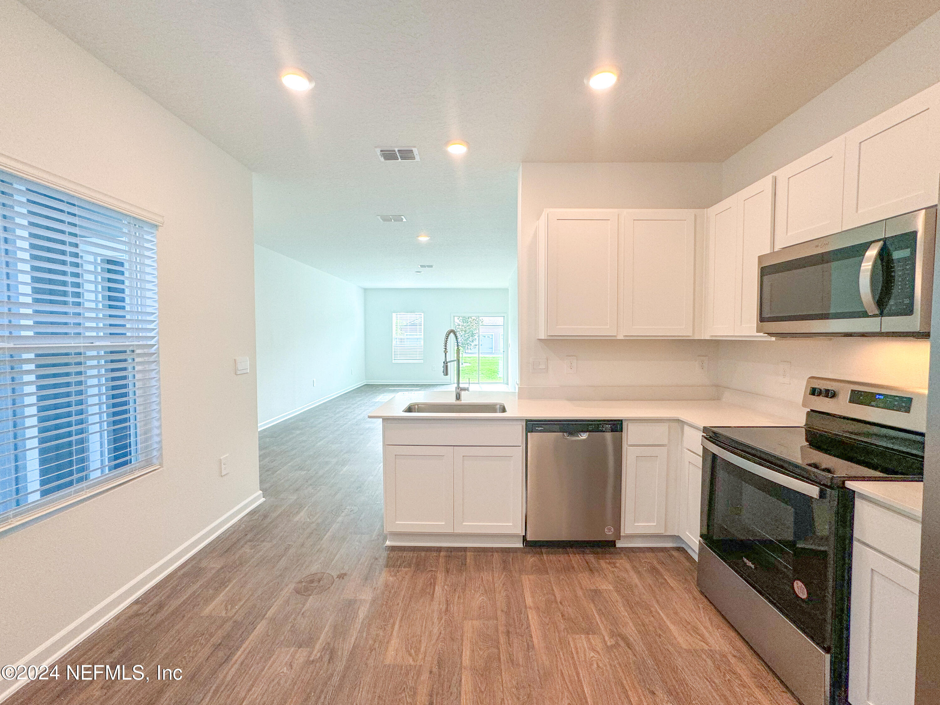 1633 Bridger Trace Middleburg, FL 32068 - Photo 11 of 26 a kitchen with a sink stove and microwave
