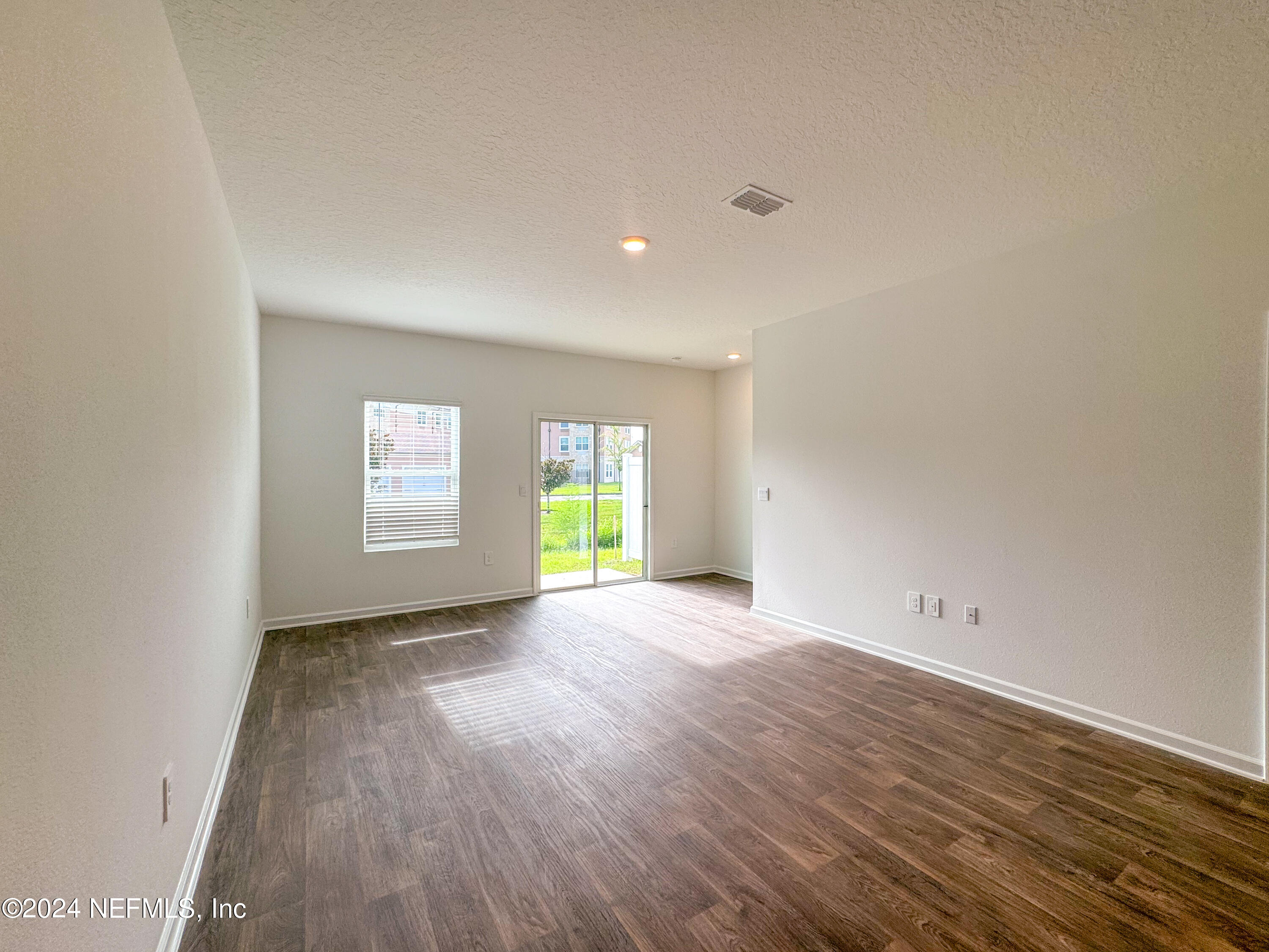 1633 Bridger Trace Middleburg, FL 32068 - Photo 13 of 26 a view of an empty room with window and wooden floor
