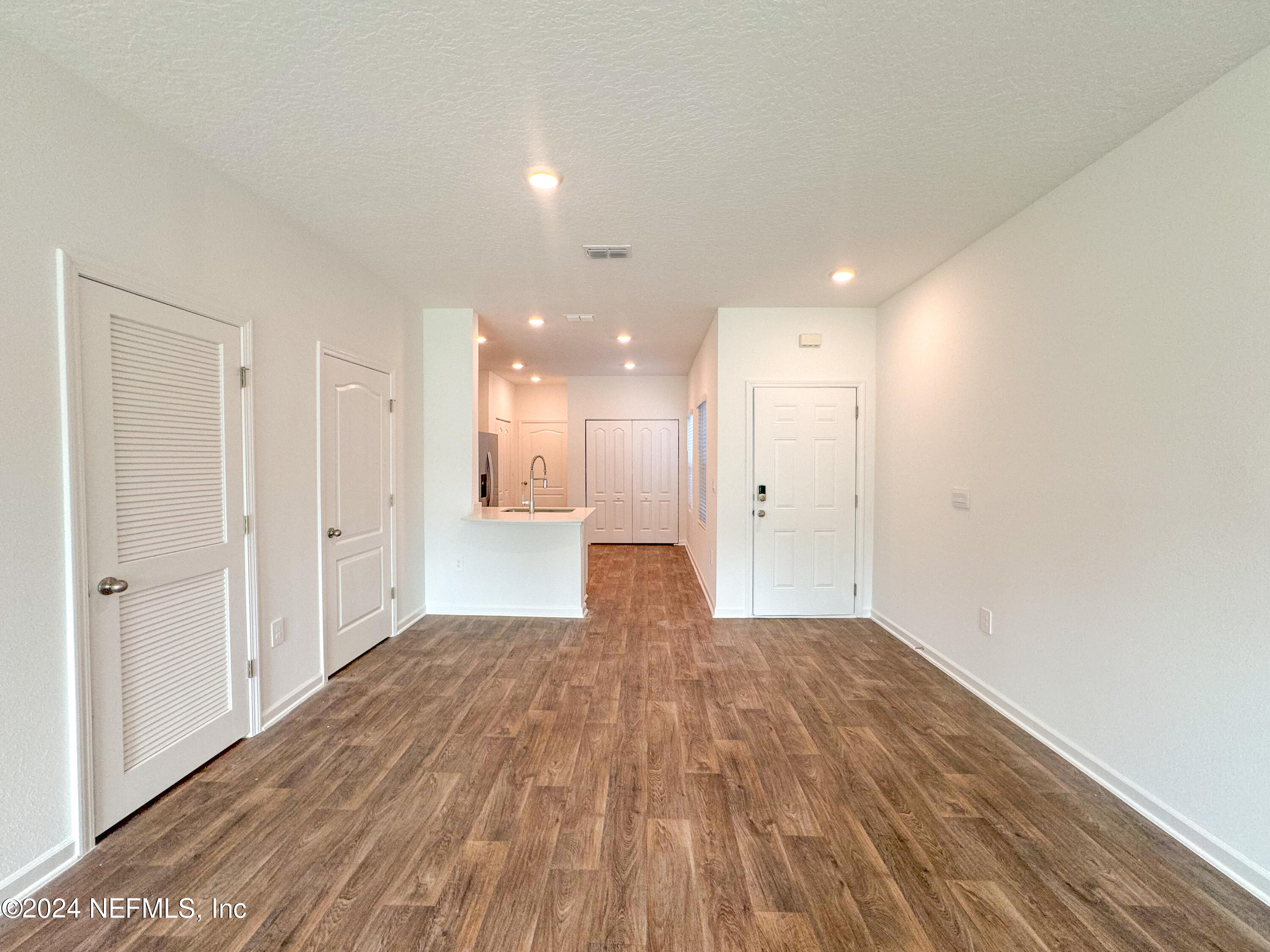 1633 Bridger Trace Middleburg, FL 32068 - Photo 14 of 26 a view of a big room with wooden floor and windows