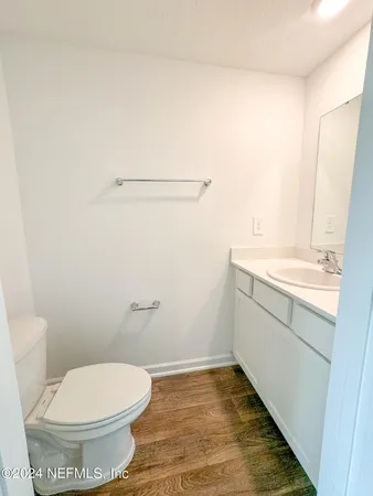 a view of a big room with wooden floor and windows