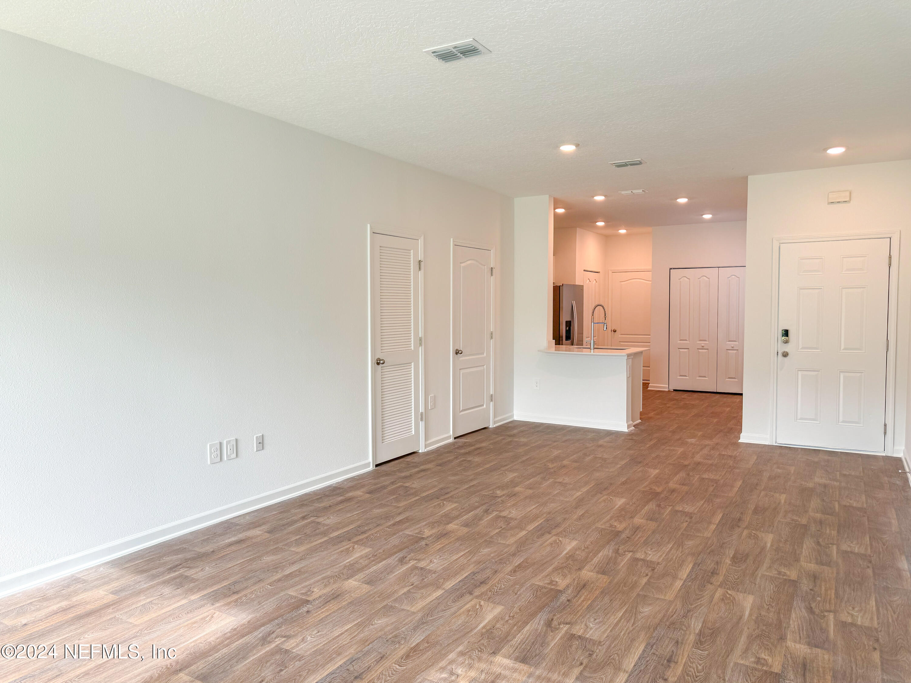 1633 Bridger Trace Middleburg, FL 32068 - Photo 17 of 26 a view of a big room with wooden floor and windows