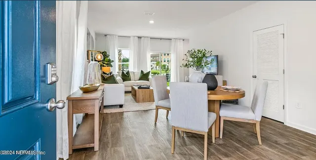 a view of a dining room with furniture window and wooden floor