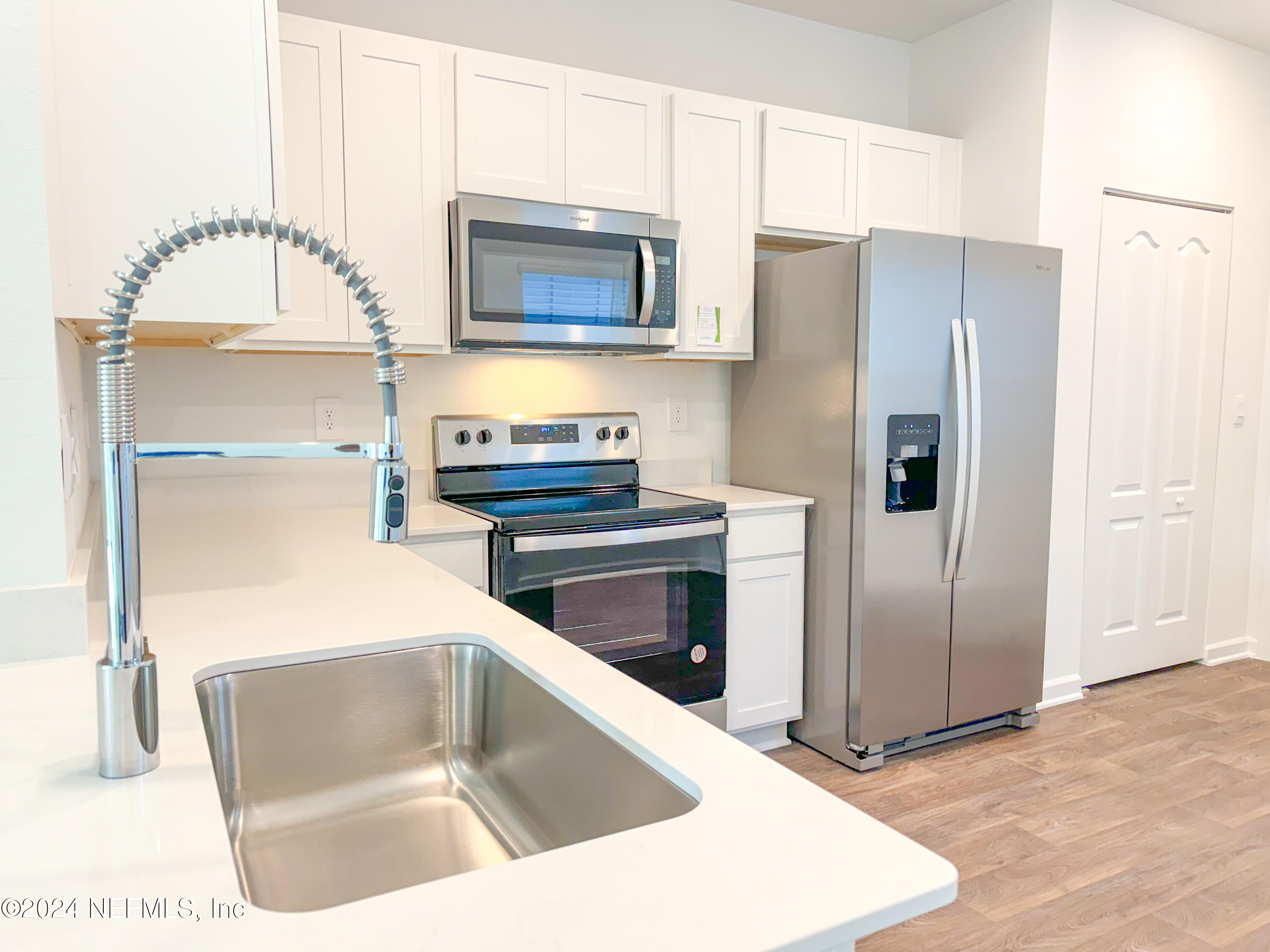 1633 Bridger Trace Middleburg, FL 32068 - Photo 7 of 26 a kitchen with granite countertop a refrigerator and a stove top oven