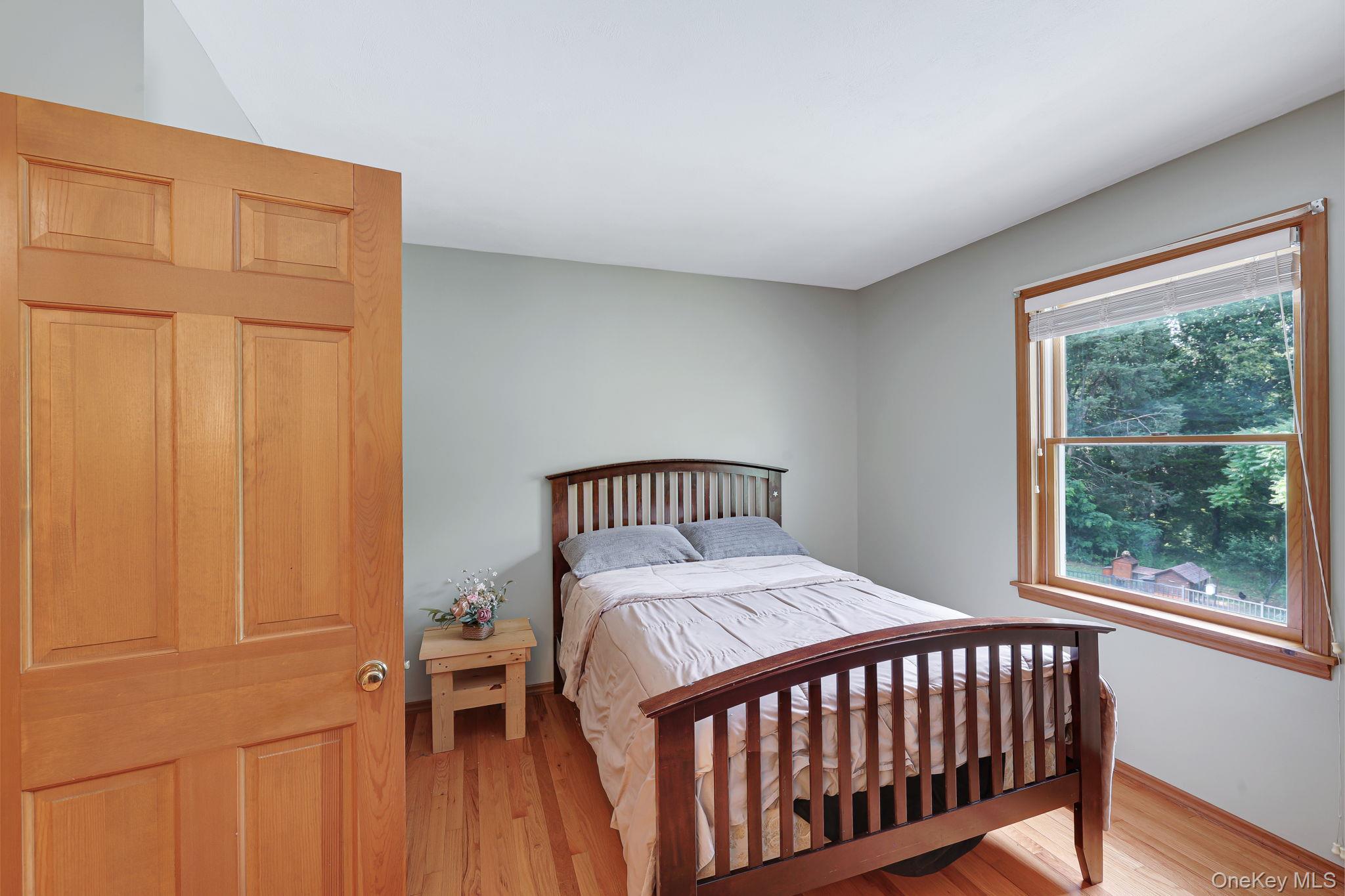 185 Rombout Road Pleasant Valley, NY 12569 - Photo 45 of 49 a bedroom with a bed and wooden floor