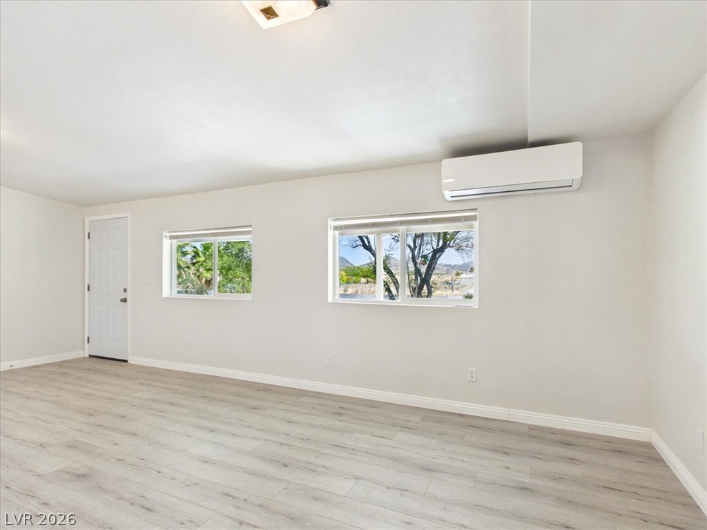 4081 Retread Road Pahrump, NV 89048 - Photo 11 of 98 Laminate flooring extends through this naturally illuminated space with two clear windows.