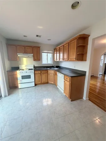 a large kitchen with a stove and a sink