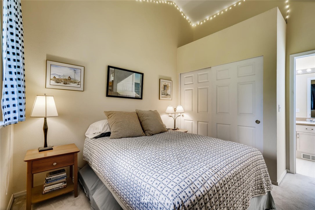 22715 4th Avenue West, Unit 104 Bothell, WA 98021 - Photo 18 of 27 a bedroom with a bed and a lamp on the dresser
