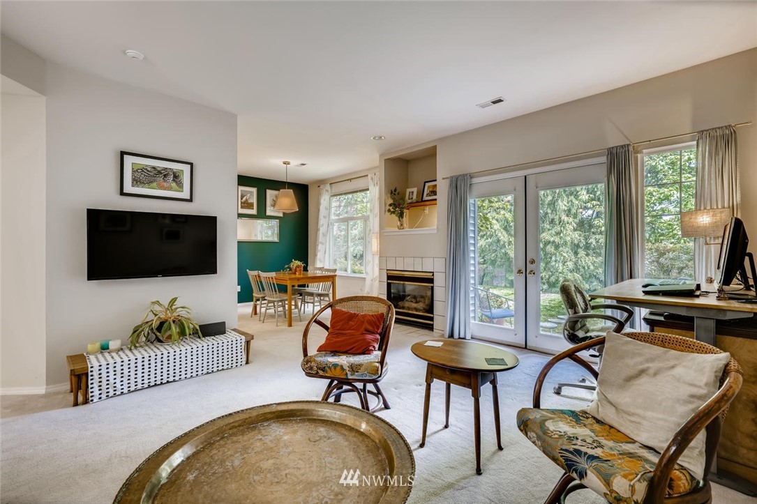 22715 4th Avenue West, Unit 104 Bothell, WA 98021 - Photo 5 of 27 a living room with furniture a flat screen tv and a large window