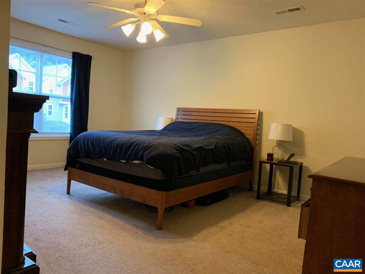 2452 North Berkshire Road Charlottesville, VA 22901 - Photo 11 of 24 a bedroom with a bed and a chandelier