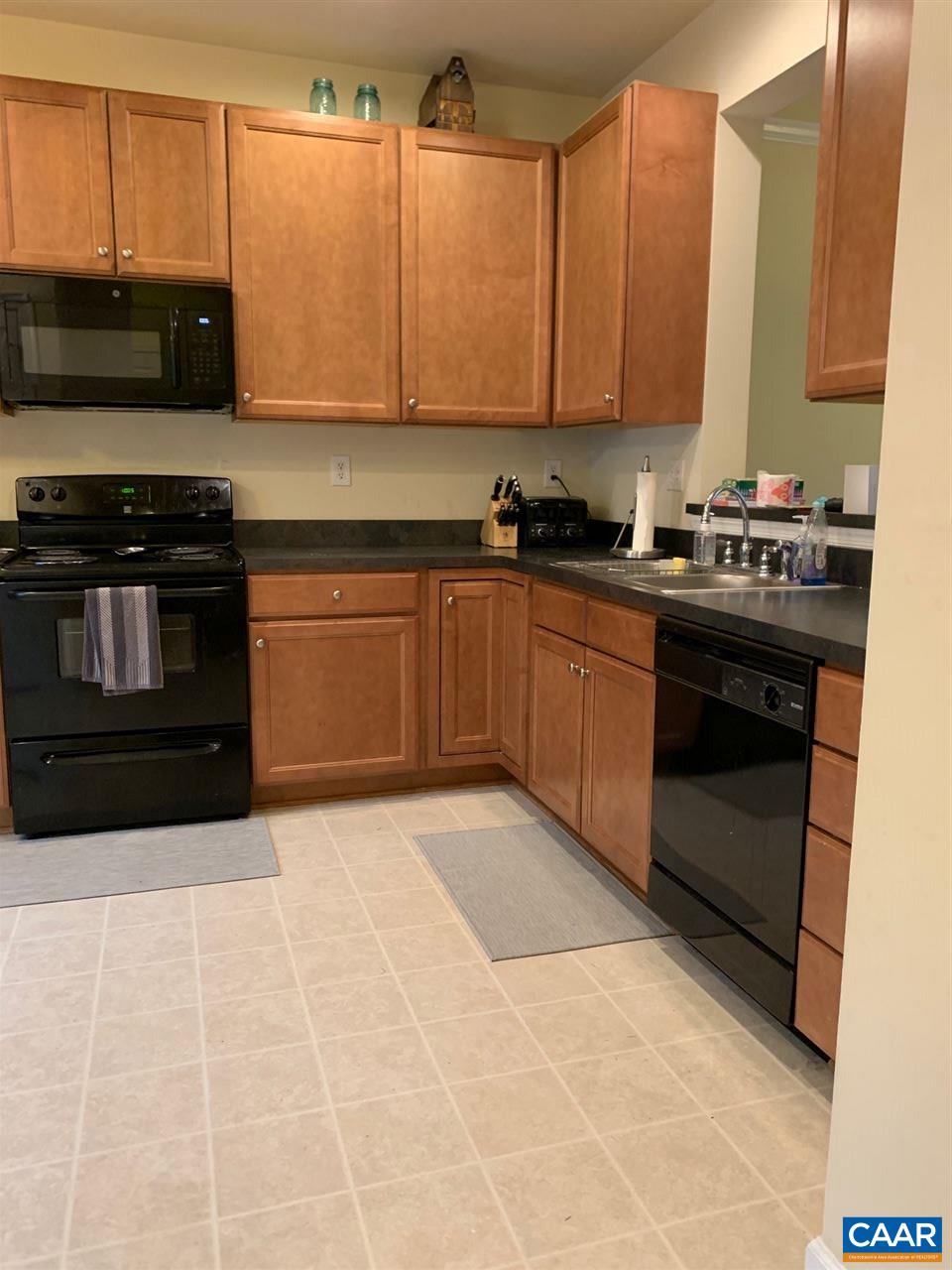 2452 North Berkshire Road Charlottesville, VA 22901 - Photo 4 of 24 a kitchen with stainless steel appliances granite countertop a stove a sink and a microwave