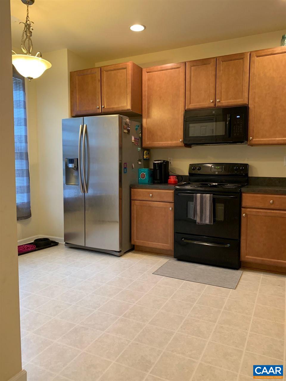 2452 North Berkshire Road Charlottesville, VA 22901 - Photo 5 of 24 a kitchen with stainless steel appliances granite countertop a refrigerator a stove a sink and a microwave