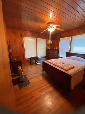 a spacious bedroom with a bed and a chandelier