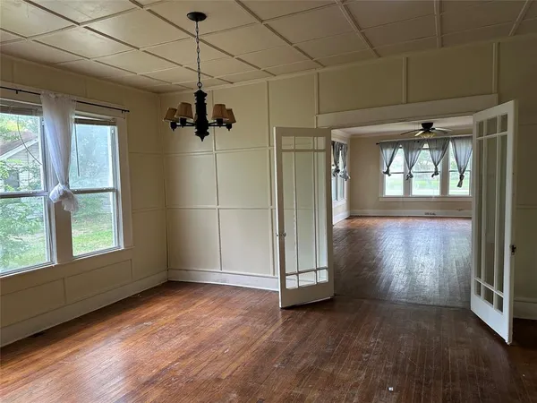 a room with a wooden floor and white walls