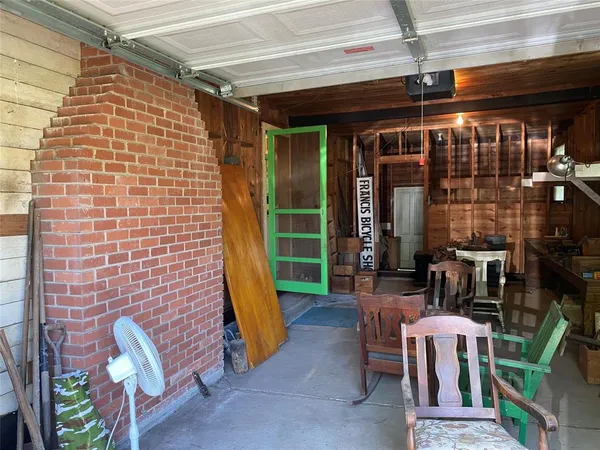 a view of a patio with a table and chairs and potted plants
