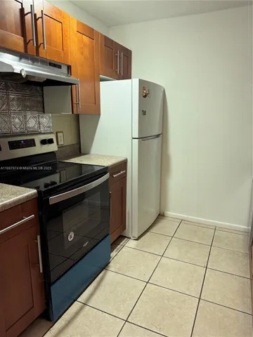 a kitchen with a stove and a refrigerator