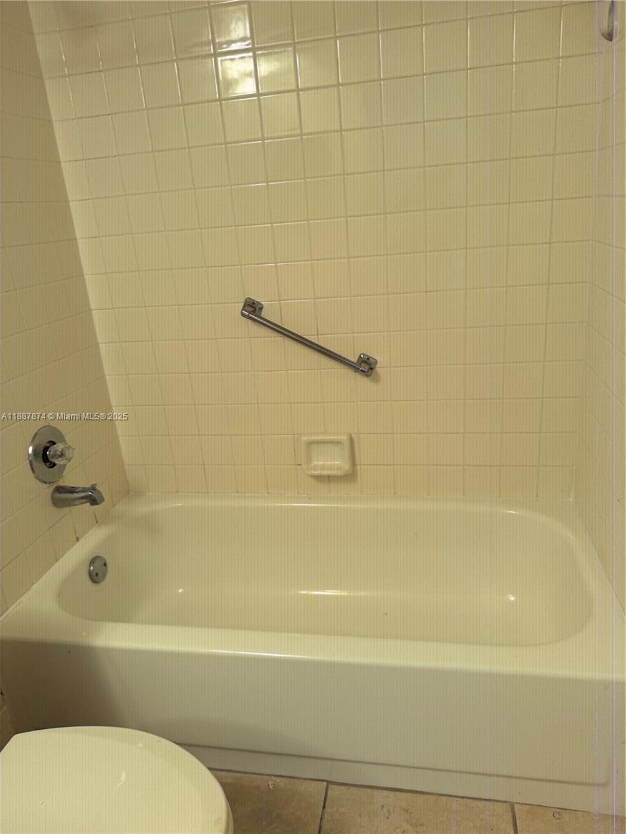 13550 Southwest 6th Court, Unit 409A Pembroke Pines, FL 33027 - Photo 11 of 20 a bathroom with a bathtub and a toilet