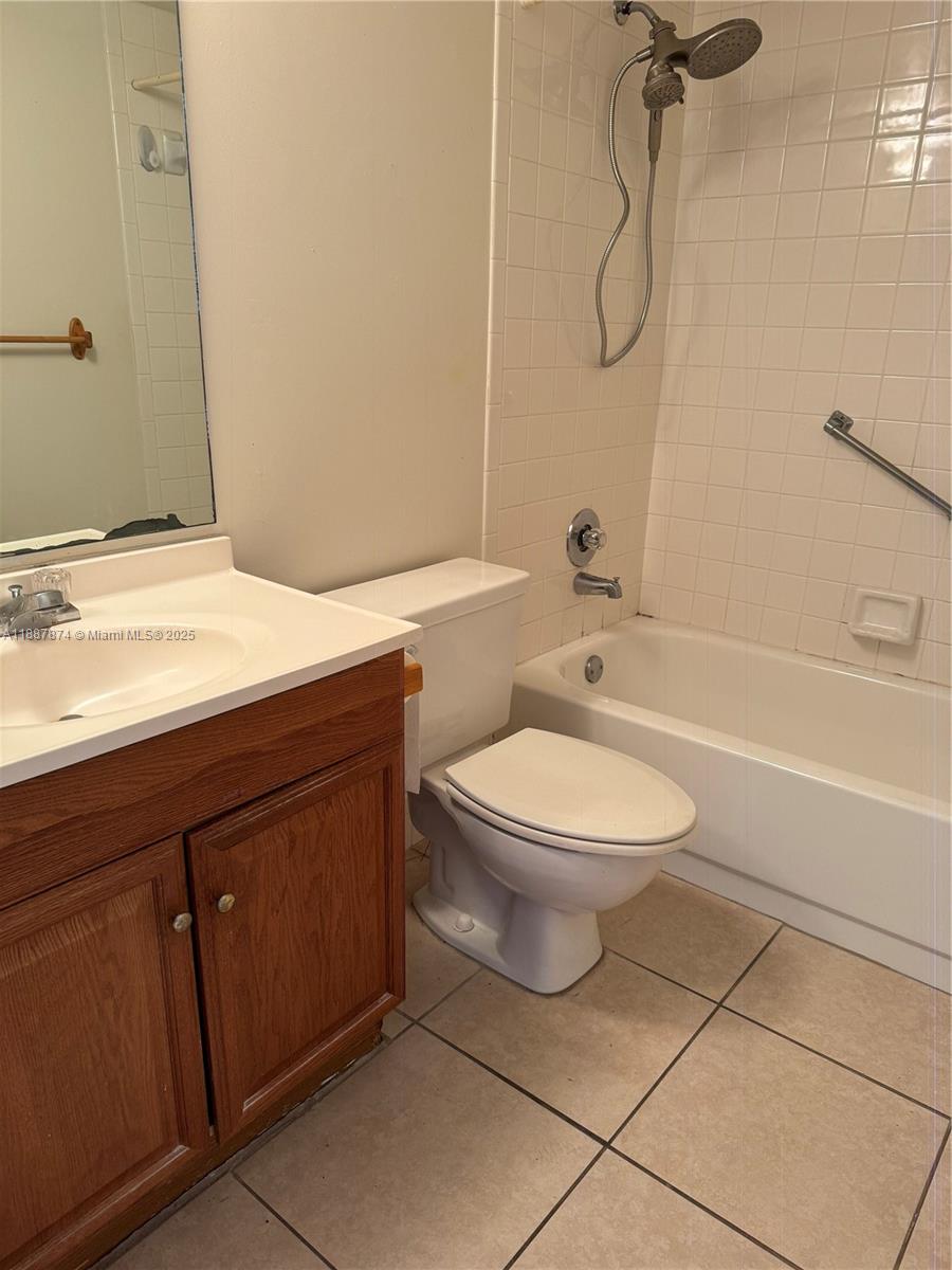 13550 Southwest 6th Court, Unit 409A Pembroke Pines, FL 33027 - Photo 12 of 20 a bathroom with a granite countertop toilet sink and shower