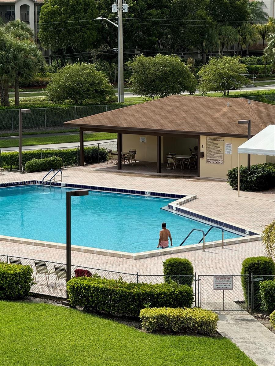 13550 Southwest 6th Court, Unit 409A Pembroke Pines, FL 33027 - Photo 20 of 20 a view of house with yard entertaining space and outdoor seating