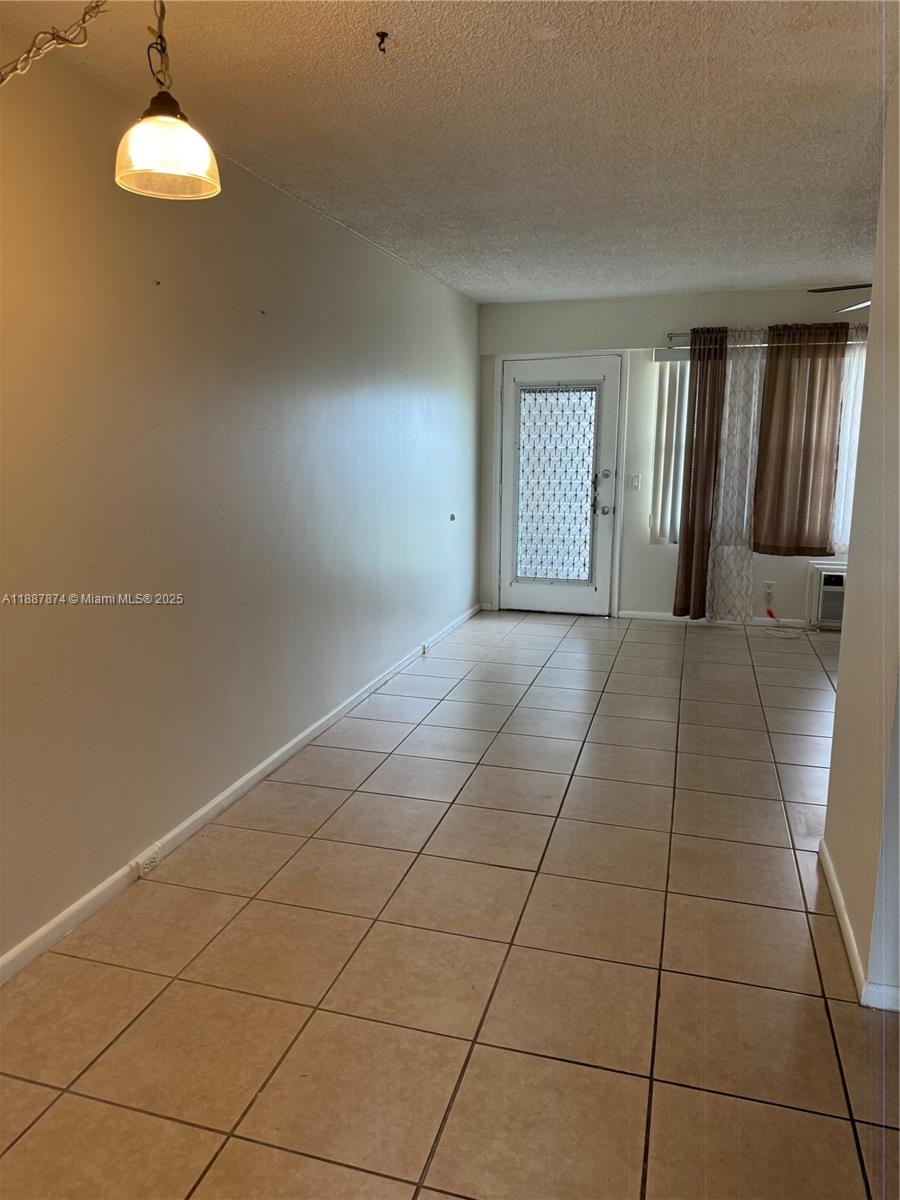 13550 Southwest 6th Court, Unit 409A Pembroke Pines, FL 33027 - Photo 8 of 20 a view of an empty room with a window