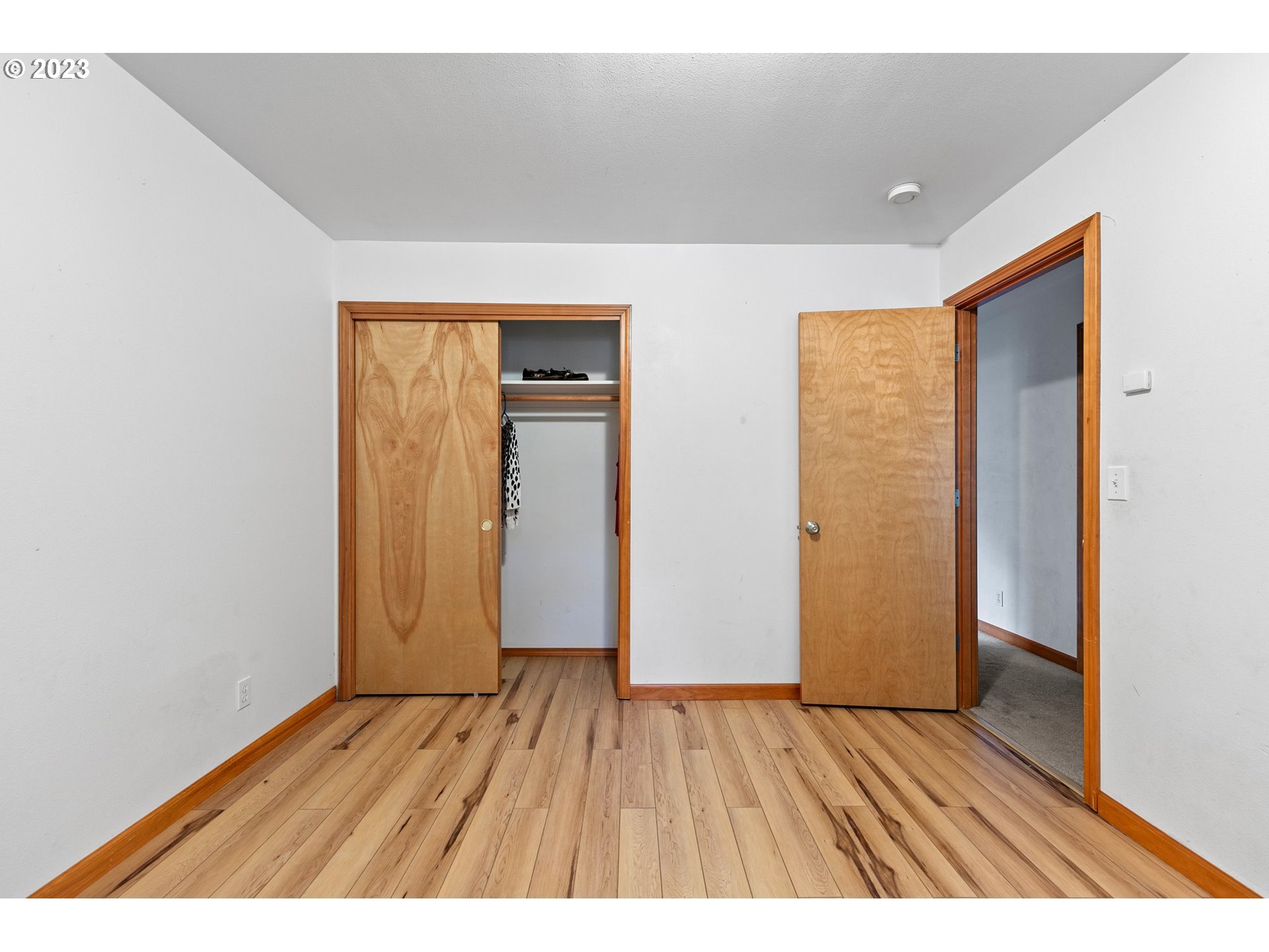 1038 Diamond Street Springfield, OR 97477 - Photo 26 of 48 an empty room with wooden floor and closet