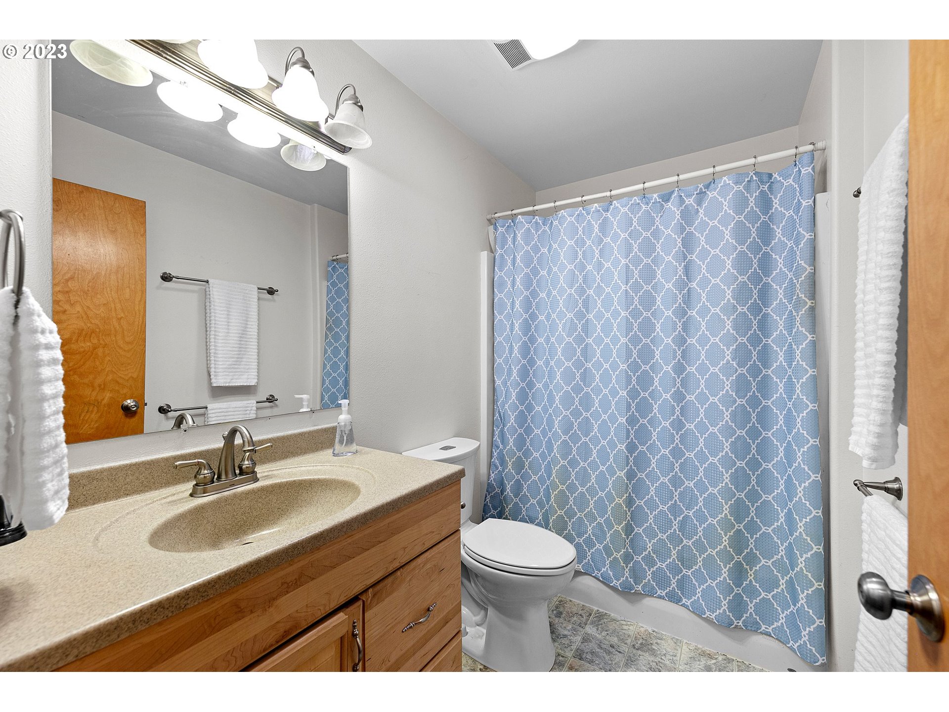 1038 Diamond Street Springfield, OR 97477 - Photo 29 of 48 a bathroom with a granite countertop sink and a mirror