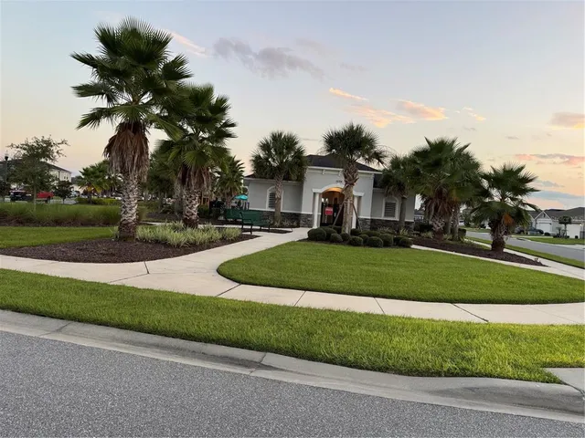 a view of a kitchen with kitchen island a sink wooden floor and a large window