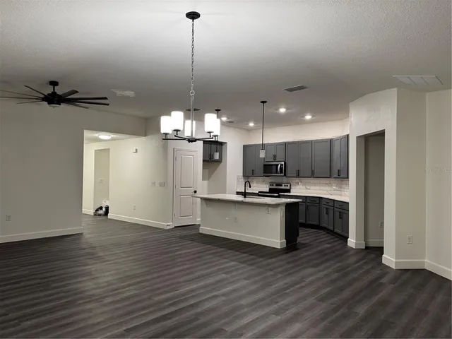 a view of an empty room and wooden floor
