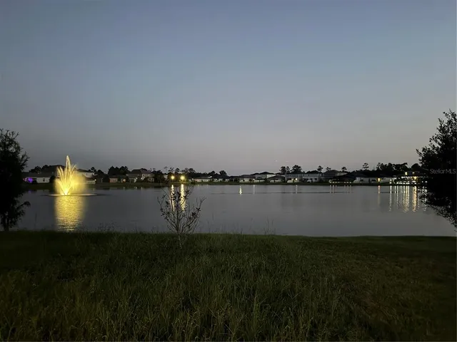 a dining room with furniture and a floor to ceiling window